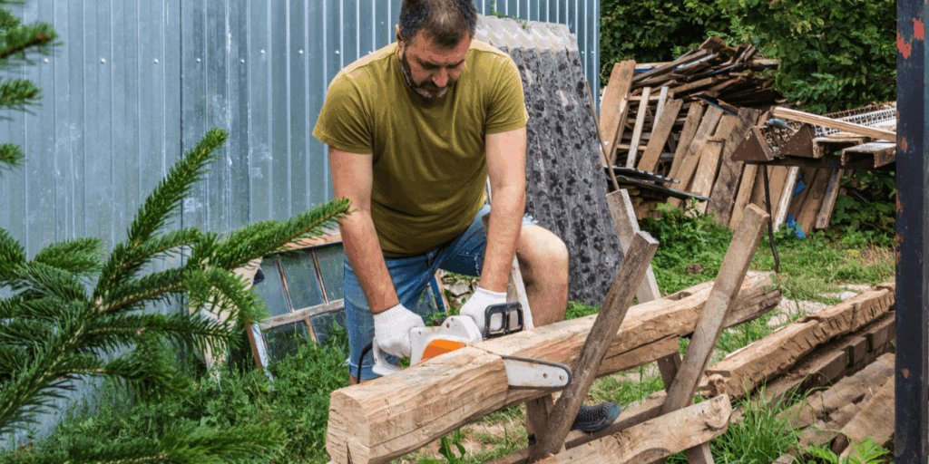  A man operates a chainsaw to cut a log into smaller pieces in a wooded area.