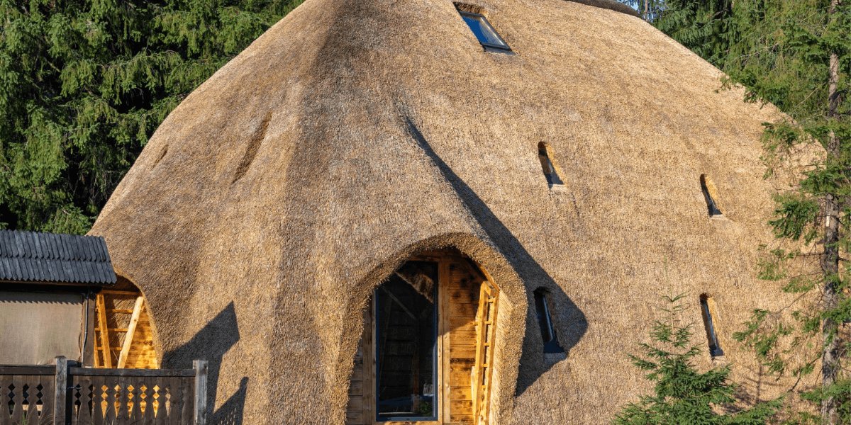 A traditional thatched house featuring a roof constructed from straw, showcasing rustic architectural style.